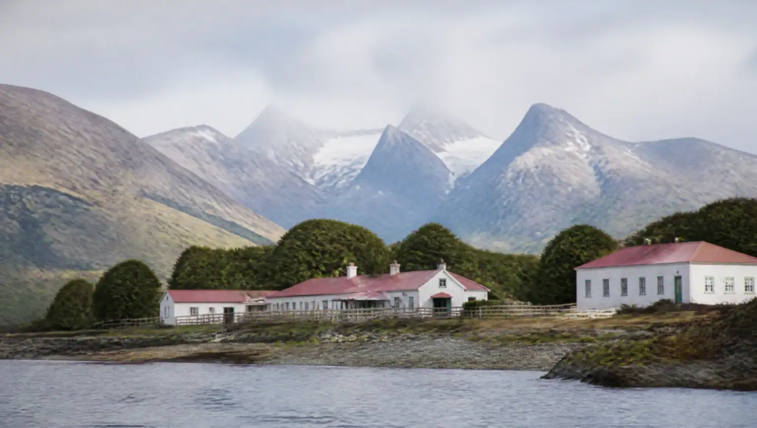 Historic white estancia buildings of Estancia Harberton on the Beagle Channel shore near Ushuaia, Tierra del Fuego