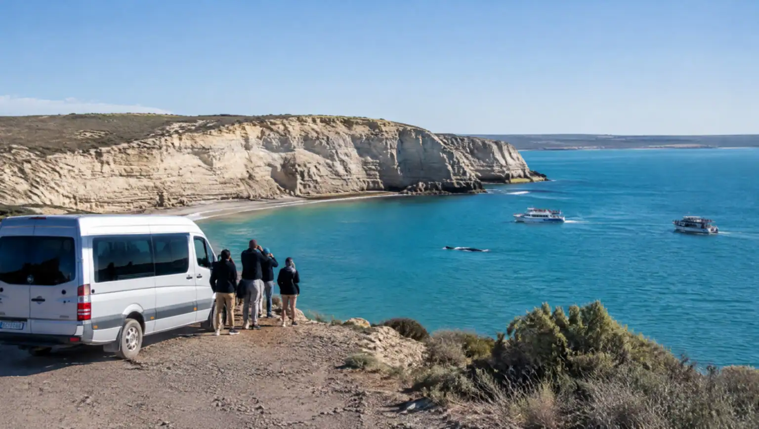 Puerto Pirámides beach and cliffs with whale-watching boats, starting point of the transfer to Puerto Madryn